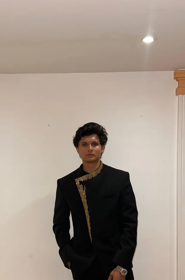 A client in a black bandhgala suit