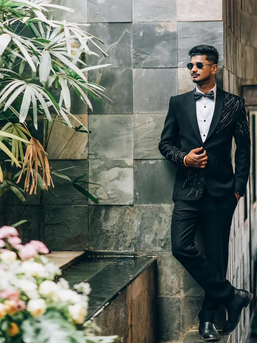 A client in a black textured tuxedo with a bow tie